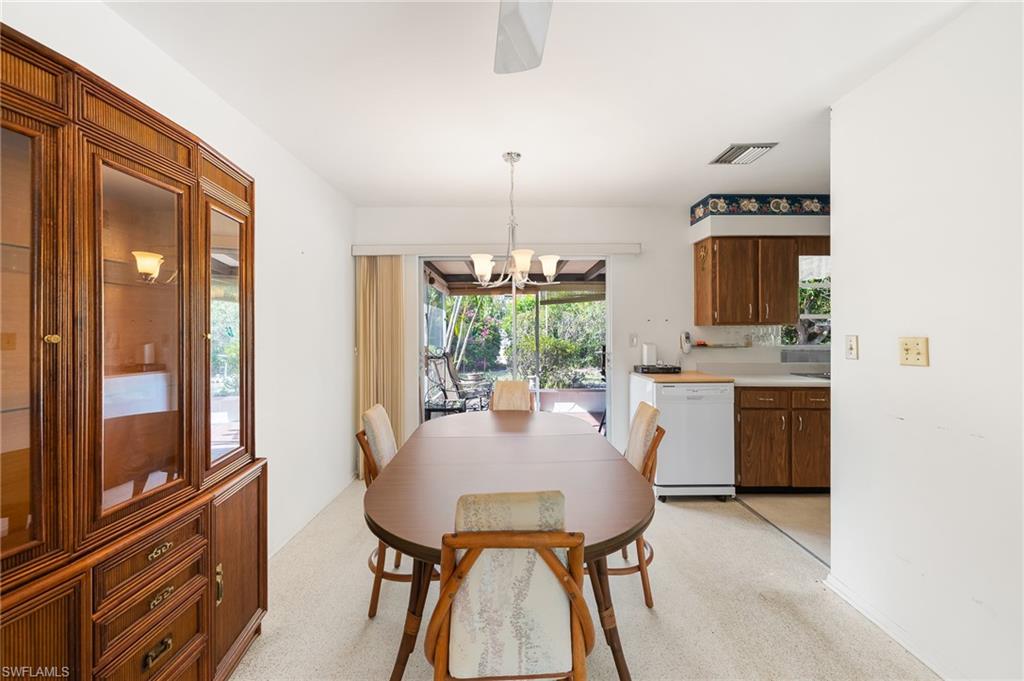 4815 Cortez Circle Naples, FL 34112 - Photo 12 of 31 a kitchen with a refrigerator and a stove top oven