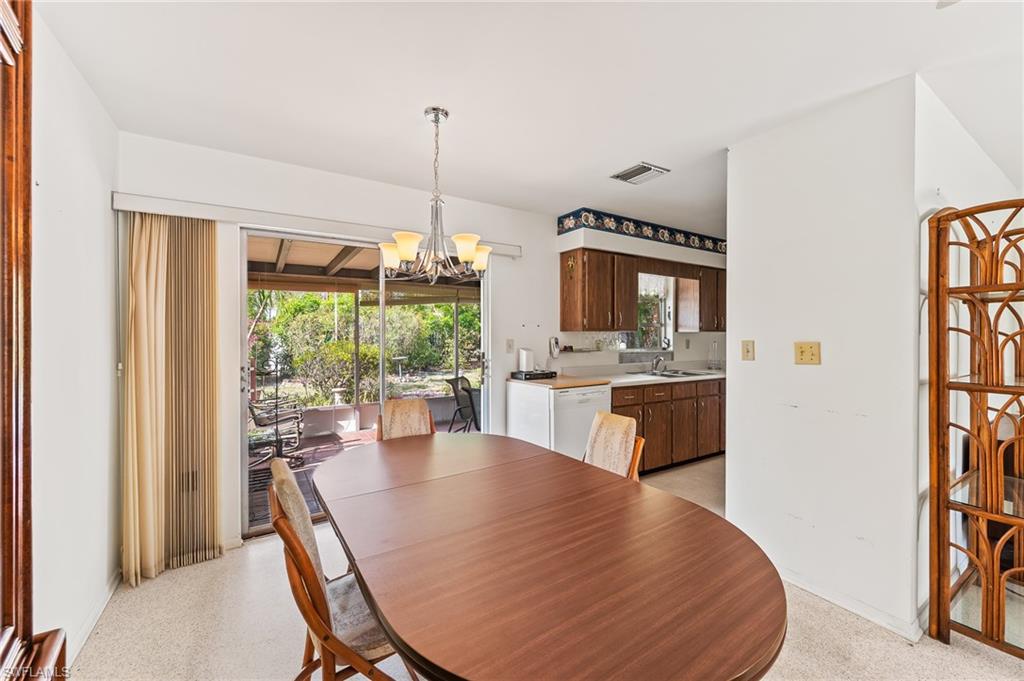 4815 Cortez Circle Naples, FL 34112 - Photo 13 of 31 a view of a dining room with furniture window and outside view