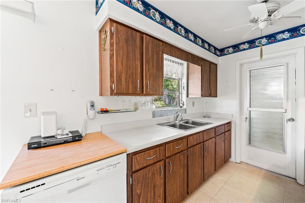 4815 Cortez Circle Naples, FL 34112 - Photo 15 of 31 a kitchen with a sink and cabinets