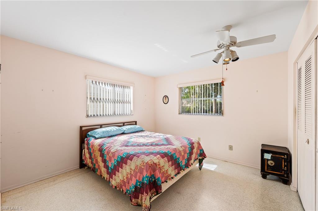 4815 Cortez Circle Naples, FL 34112 - Photo 18 of 31 a bedroom with a bed and a window