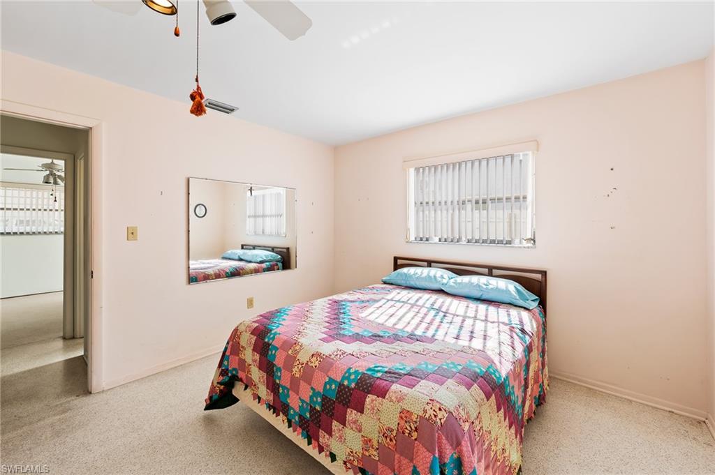4815 Cortez Circle Naples, FL 34112 - Photo 21 of 31 a bedroom with a bed and a window