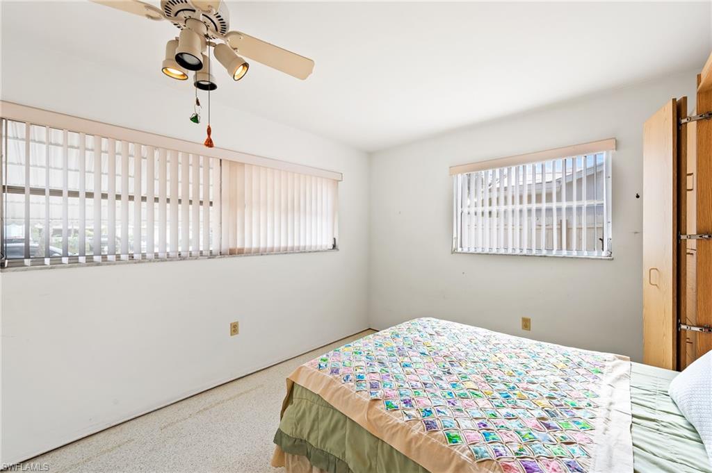4815 Cortez Circle Naples, FL 34112 - Photo 23 of 31 a bedroom with a bed and a window