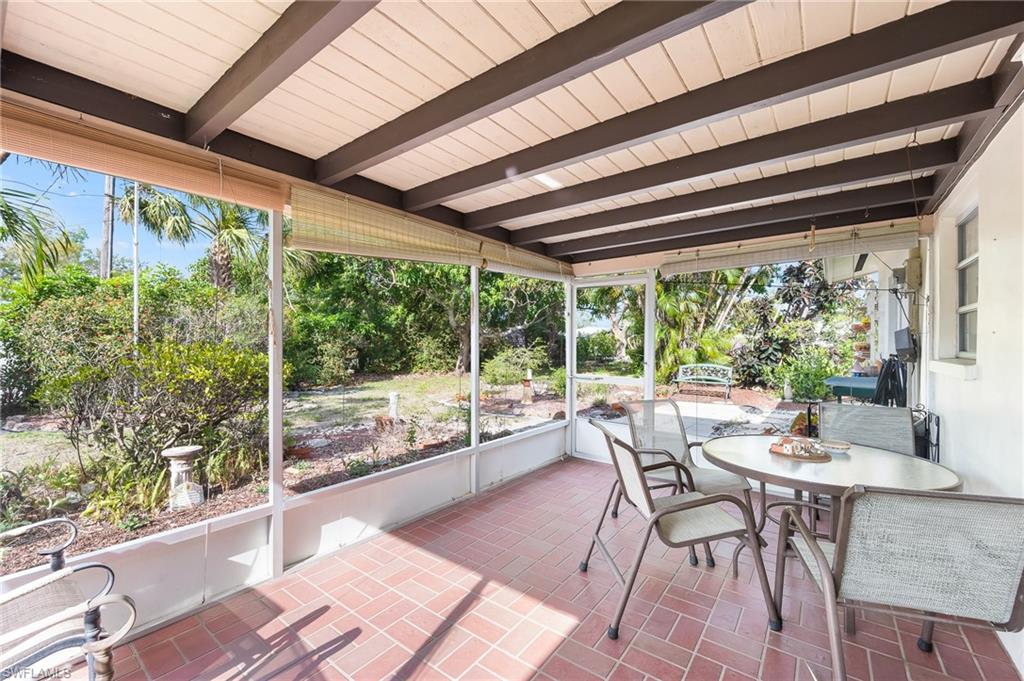 4815 Cortez Circle Naples, FL 34112 - Photo 27 of 31 a dining room with wooden floor wooden floor and outdoor seating