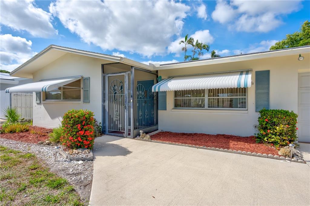 4815 Cortez Circle Naples, FL 34112 - Photo 4 of 31 a house view with a garden space