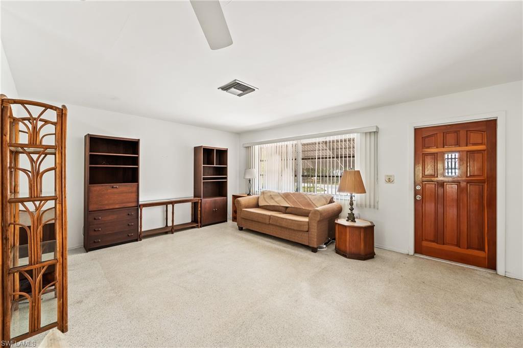 4815 Cortez Circle Naples, FL 34112 - Photo 7 of 31 a living room with furniture rug and window