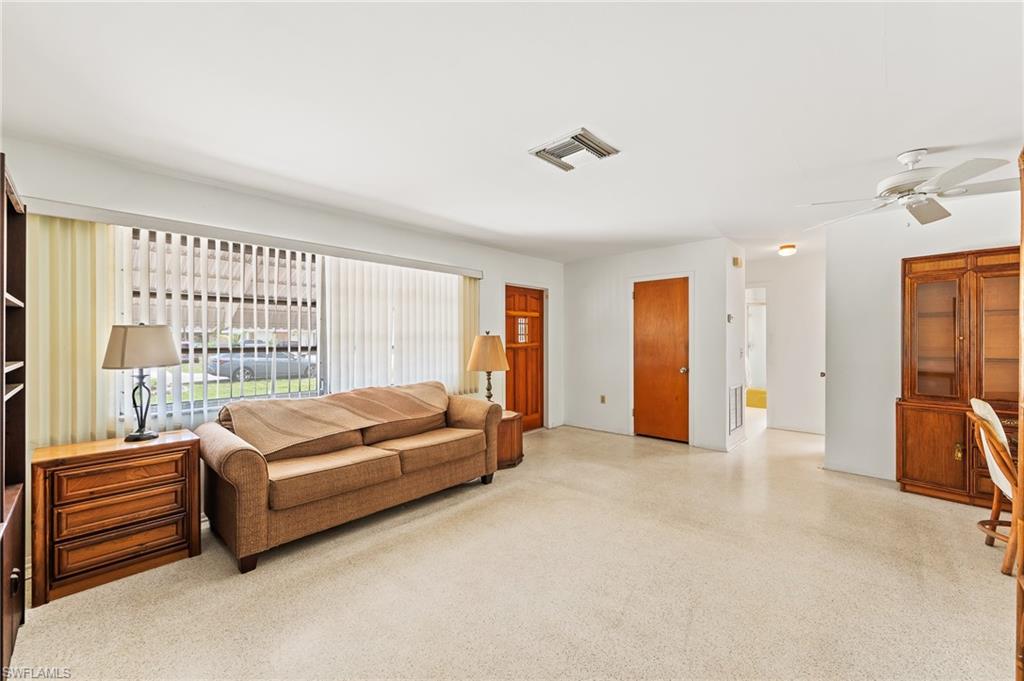 4815 Cortez Circle Naples, FL 34112 - Photo 8 of 31 a living room with furniture and a large window