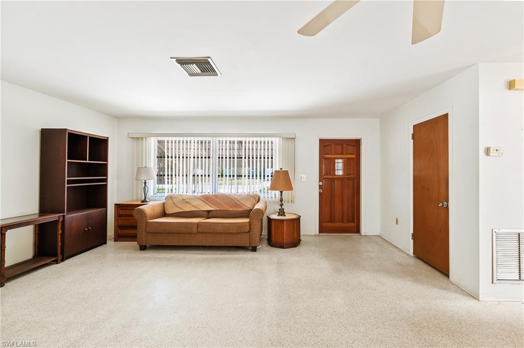 4815 Cortez Circle Naples, FL 34112 - Photo 10 of 31 a living room with furniture and a flat screen tv