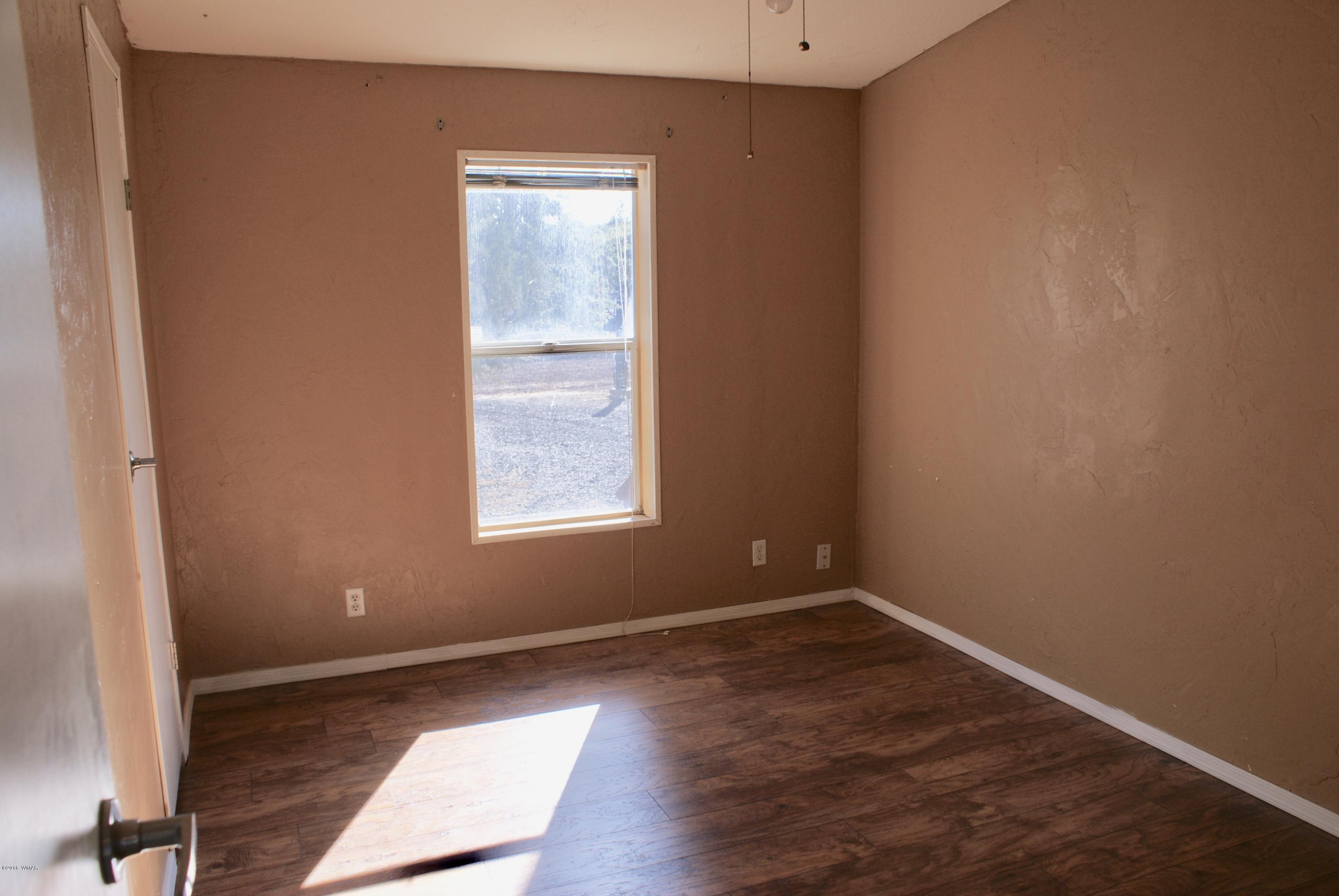 Lot 66 Antelope Vernon, AZ 85940 - Photo 14 of 17 an empty room with wooden floor and windows
