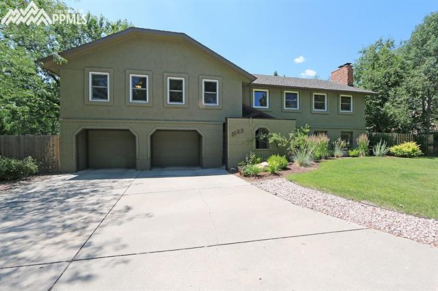 3123 Springdowns Place Colorado Springs, CO 80906 - Photo 4 of 36 Garage has lockable closet outside of each door. Private entryway. Mature landscaping.