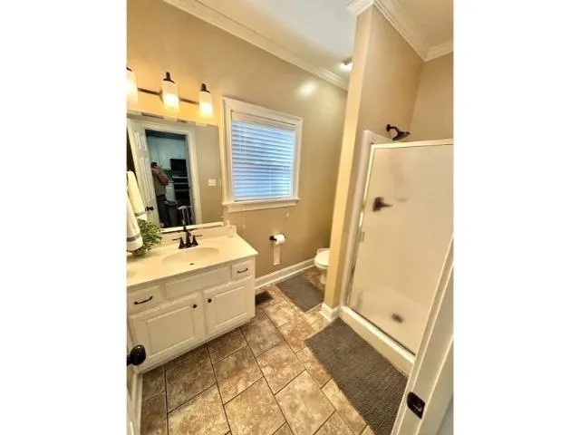 view of a bathroom with a sink a mirror and a shower