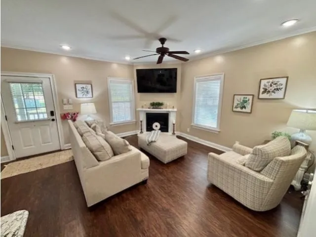 a living room with furniture flat screen tv and a fireplace
