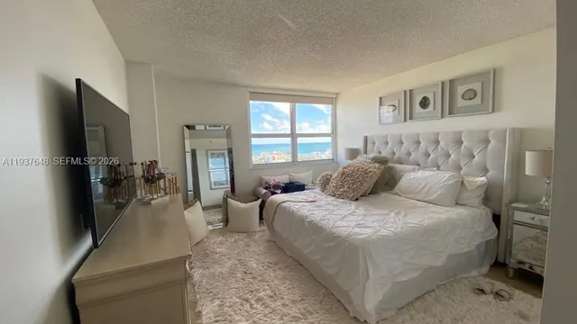 a bed room with a bed and a television