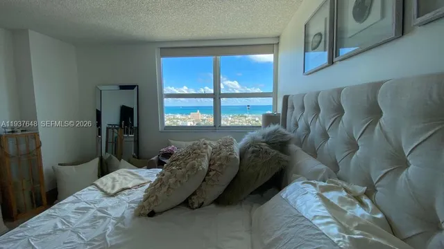 a bed sitting in a bedroom next to a window