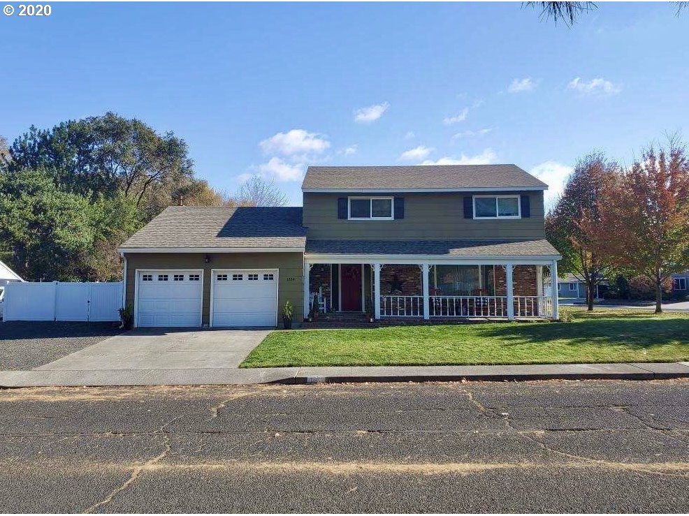 1554 Southwest 44th Street Pendleton, OR 97801 - Photo 2 of 22 a front view of a house with a garden and trees