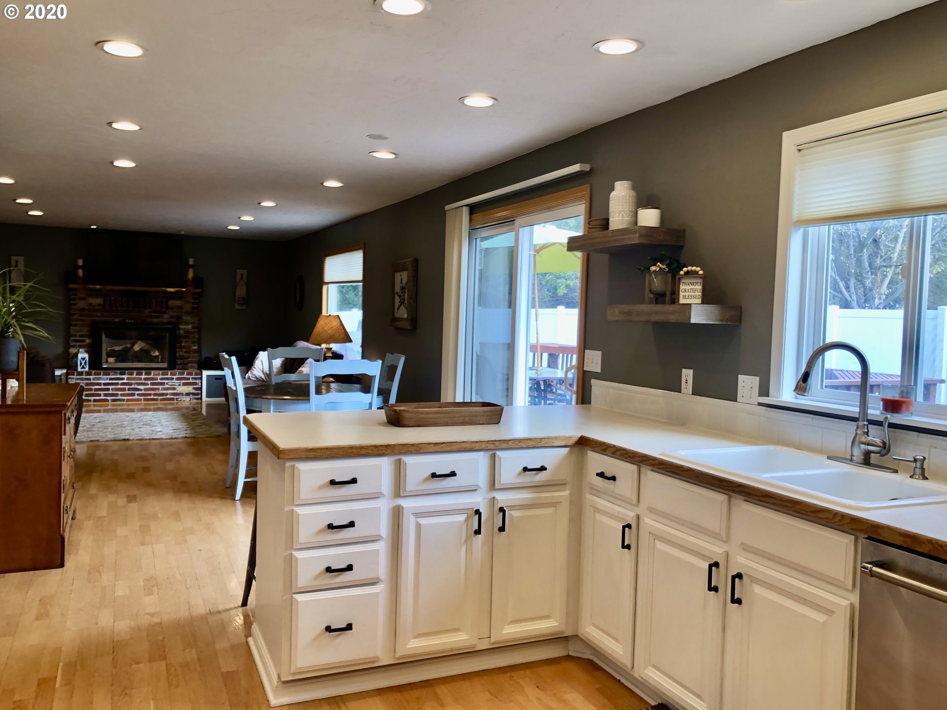1554 Southwest 44th Street Pendleton, OR 97801 - Photo 7 of 22 a kitchen with stainless steel appliances kitchen island granite countertop a sink and cabinets