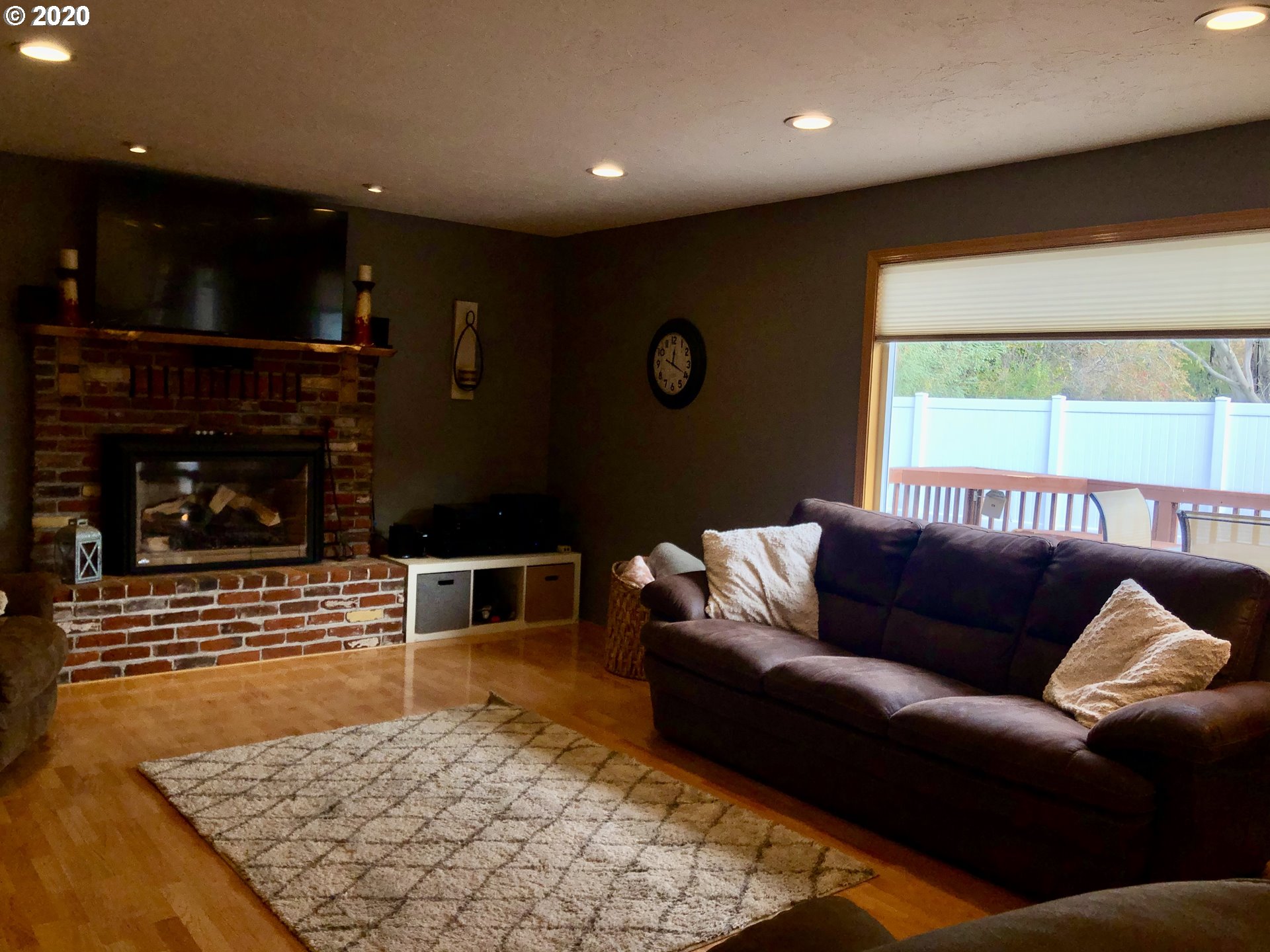 1554 Southwest 44th Street Pendleton, OR 97801 - Photo 8 of 22 a living room with furniture a flat screen tv and a fireplace