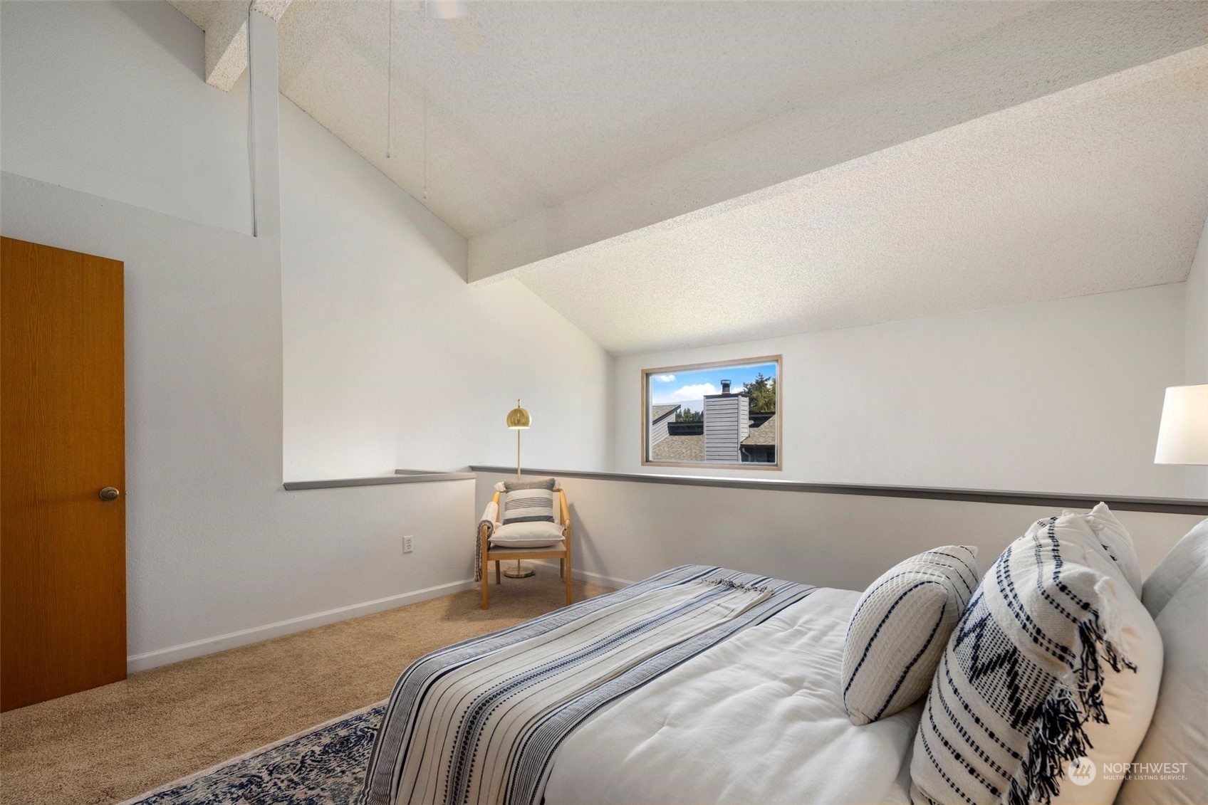 21658 14th Avenue South, Unit A10 Des Moines, WA 98198 - Photo 15 of 39 a bedroom with a bed and a painting on the wall