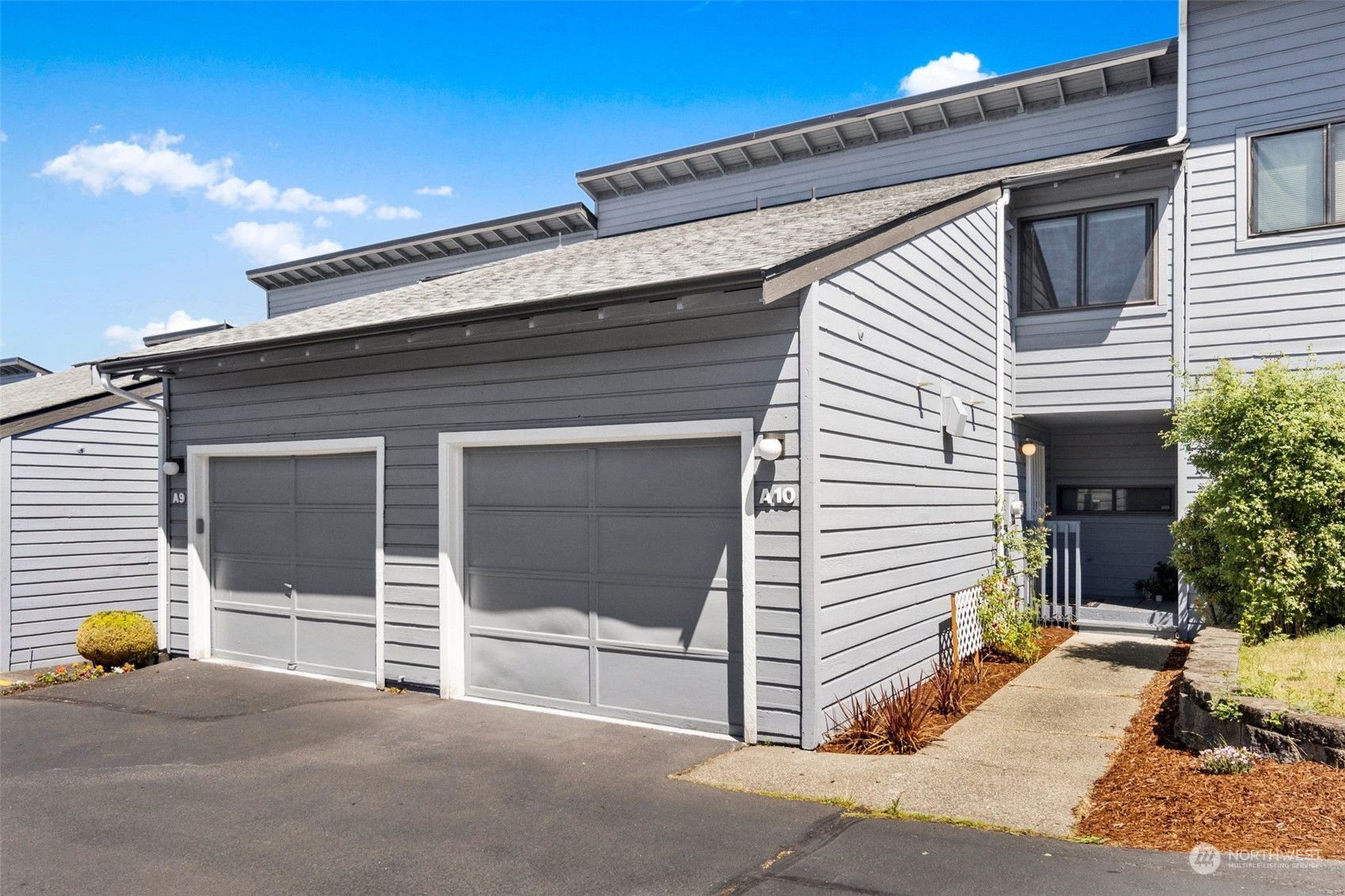 21658 14th Avenue South, Unit A10 Des Moines, WA 98198 - Photo 2 of 39 a view of a house with a door and a yard