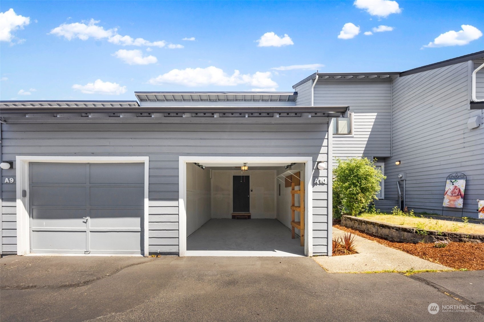 21658 14th Avenue South, Unit A10 Des Moines, WA 98198 - Photo 21 of 39 a view of a hallway with wooden floor and a yard
