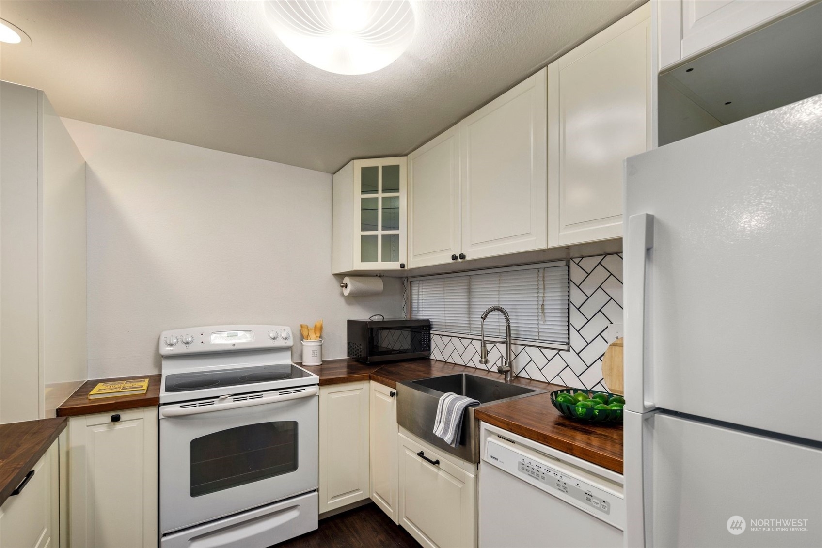 21658 14th Avenue South, Unit A10 Des Moines, WA 98198 - Photo 8 of 39 a kitchen with white cabinets and white appliances
