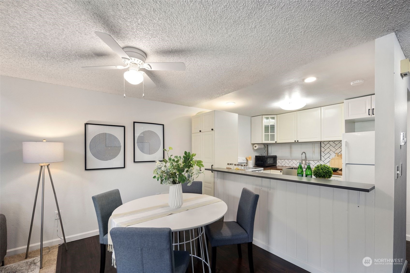 21658 14th Avenue South, Unit A10 Des Moines, WA 98198 - Photo 10 of 39 a dining room with furniture and a lamp