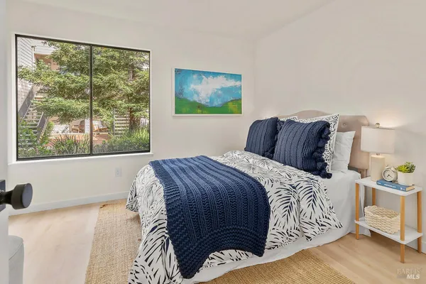 a bedroom with a large bed and a window