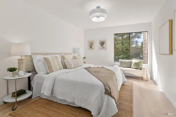 a bedroom with a bed and window