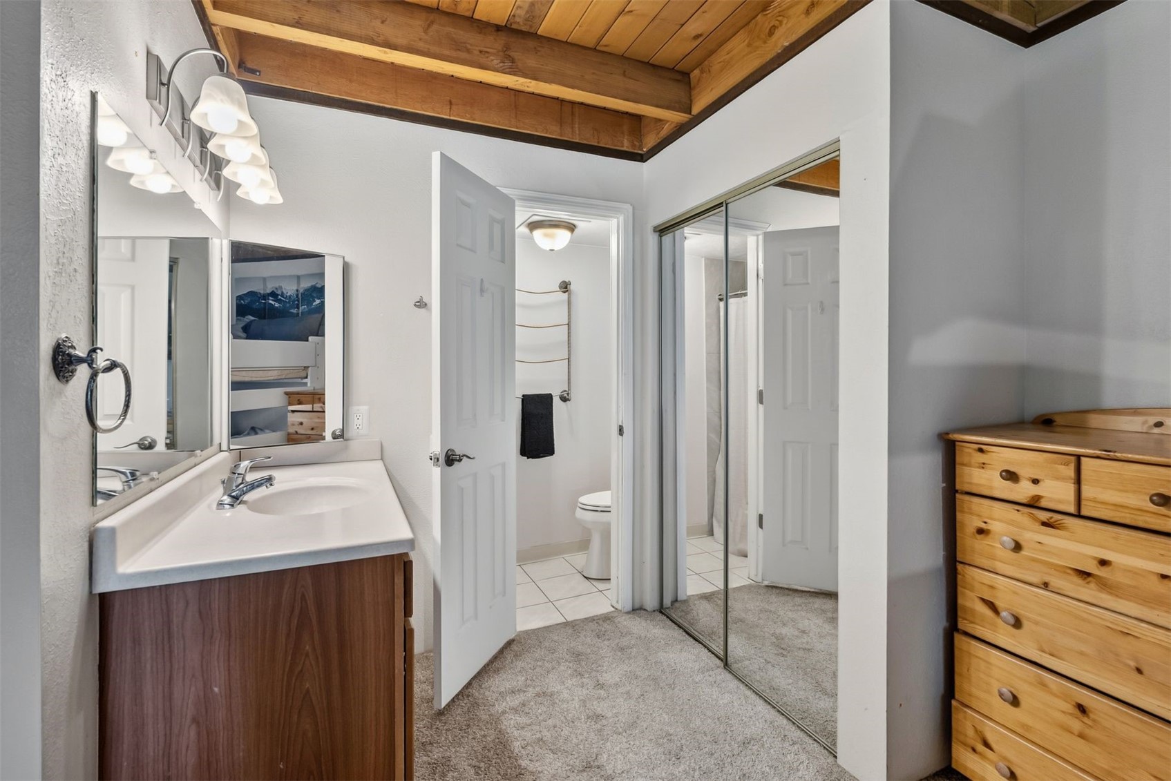 8100 Ryan Gulch Road, Unit 106 Wildernest, CO 80498 - Photo 14 of 43 a bathroom with a sink a toilet and shower
