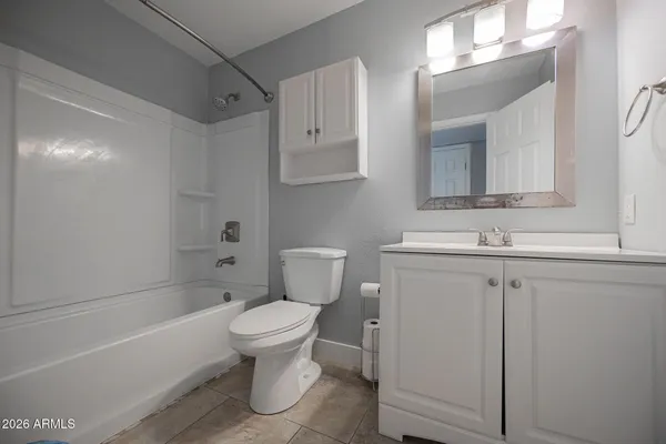 a bathroom with a sink toilet vanity and shower