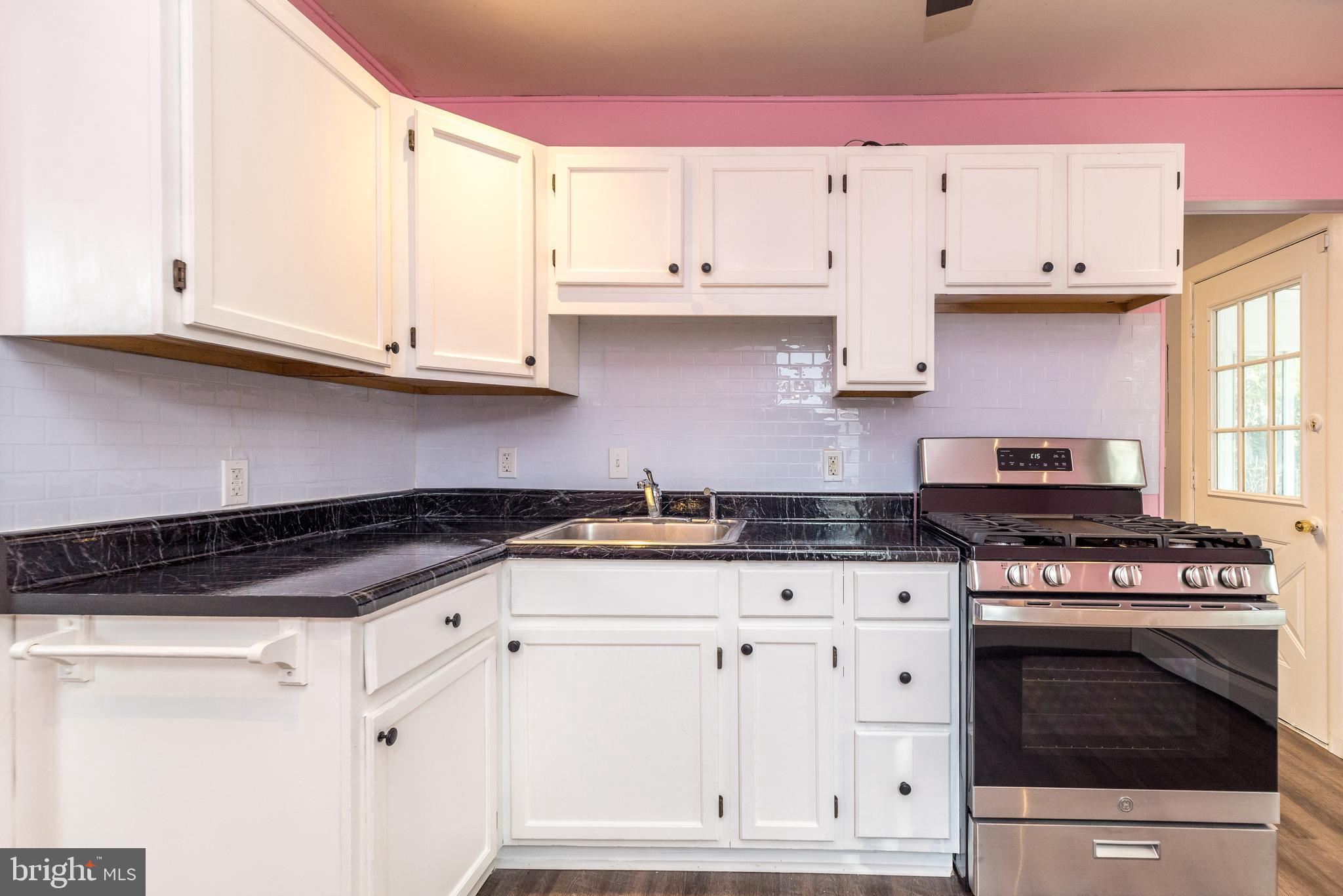 1000 Stephen Avenue Croydon, PA 19021 - Photo 11 of 20 a kitchen with granite countertop white cabinets and stainless steel appliances
