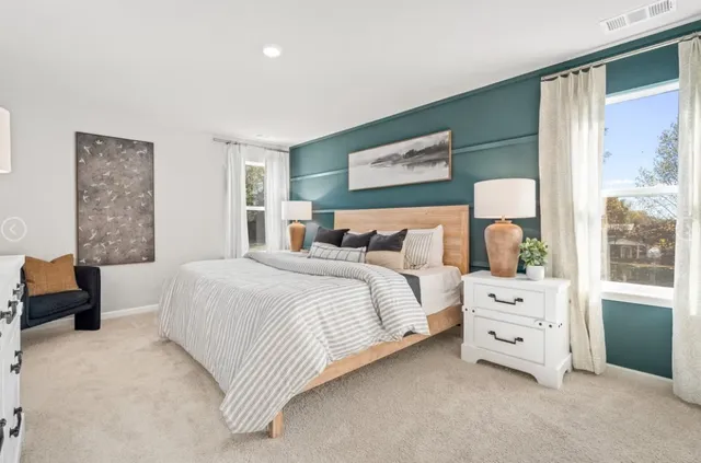 a bedroom with a bed and a large window