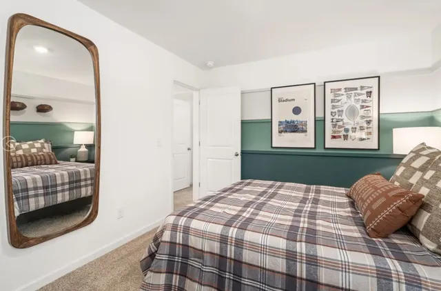 a bedroom with a bed and a mirror