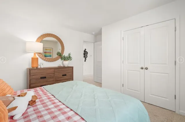 a bed room with a bed and a dresser