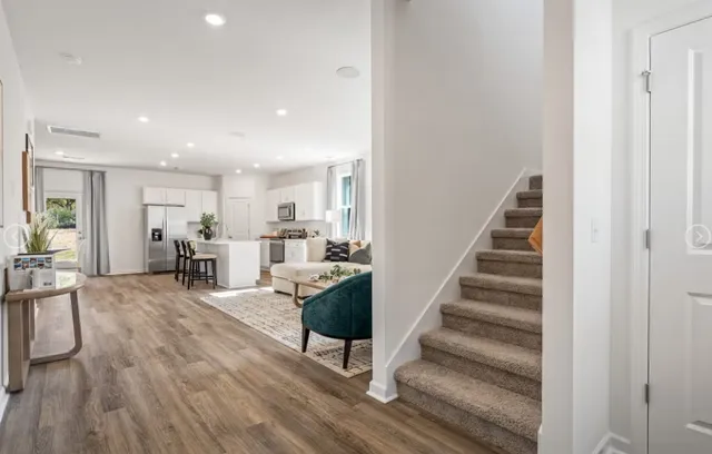 a living room with furniture and wooden floor