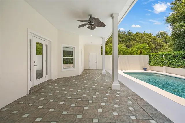 a view of a dining room and livingroom with furniture wooden floor a chandelier