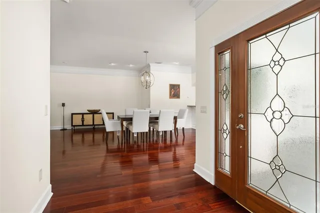 a view of a dining room with furniture wooden floor and chandelier