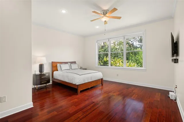 a bed sitting in a bedroom next to a window