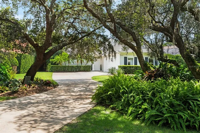 a view of backyard of house with green space