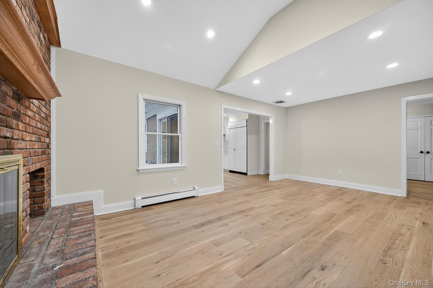 43 Edcris Lane Huntington, NY 11724 - Photo 12 of 37 a view of an empty room with wooden floor and a window