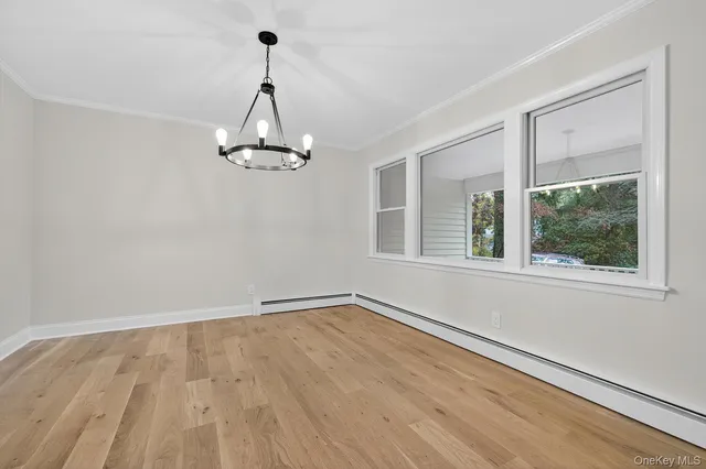 a view of a room with wooden floor cabinet and windows