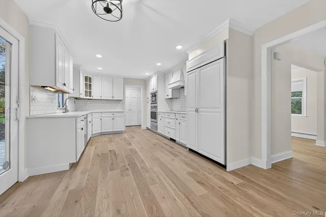 a kitchen with wooden floors and white appliances