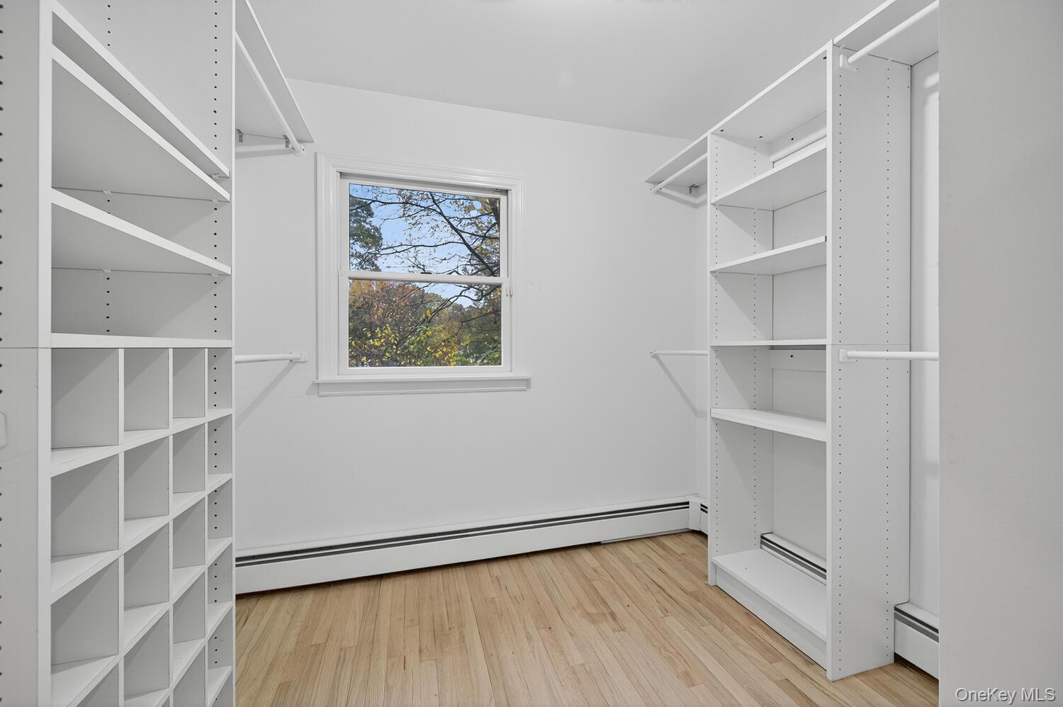 43 Edcris Lane Huntington, NY 11724 - Photo 24 of 37 a view of an empty room with a window and wooden floor