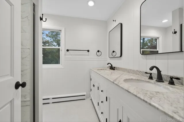 a bathroom with a granite countertop sink mirror and vanity