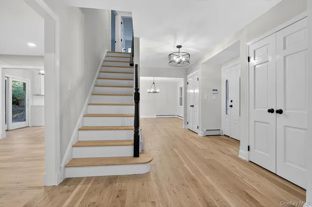 a view of a hallway with wooden floor and entryway