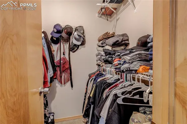 a view of walk in closet with clothes