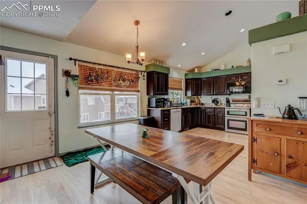 a large kitchen with kitchen island a table and chairs in it