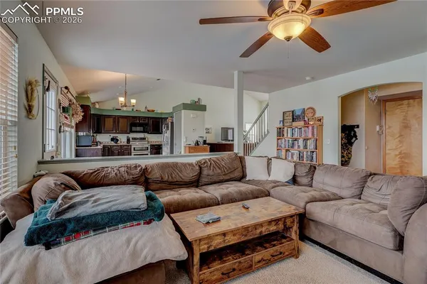 a living room with furniture and a chandelier