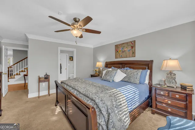 a bedroom with a large bed and a window