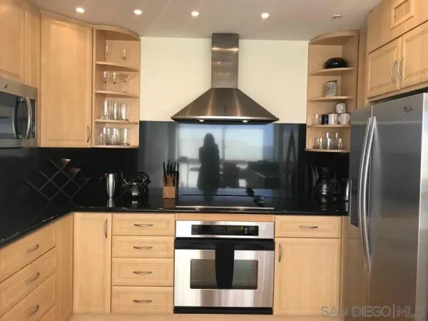 a kitchen with stainless steel appliances a refrigerator and cabinets
