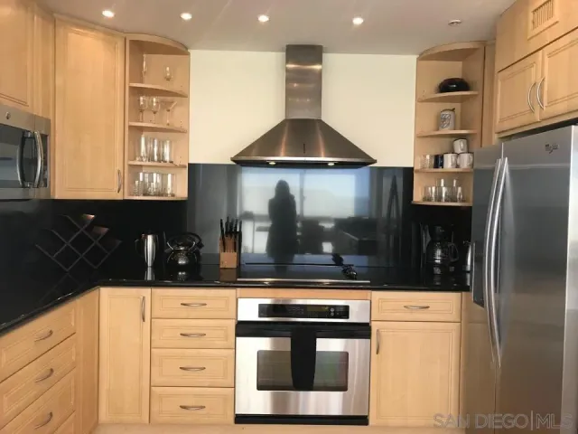 a kitchen with stainless steel appliances a refrigerator and cabinets